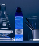 1% Blue Peptide Cica Skin Booster glowing blue between lab flasks and spatulas