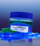 1% Blue Peptide Cica Serum jar surrounded by blue water gel and green oil gel texture