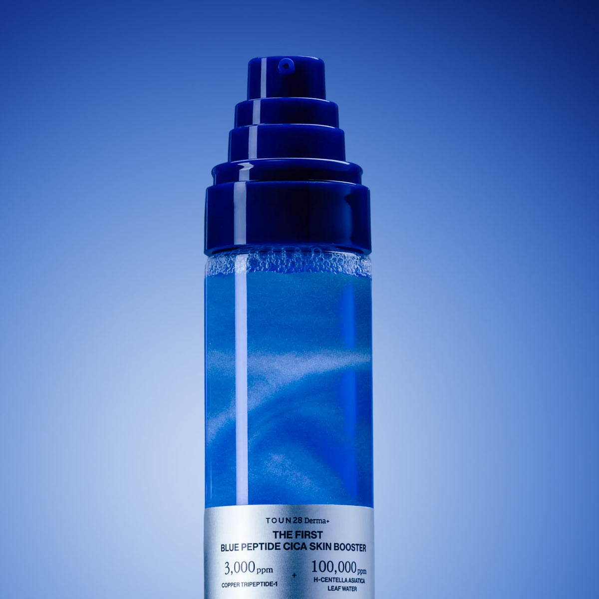 Close-up of 1% Blue Peptide Cica Skin Booster pump bottle with shimmering blue liquid