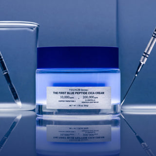1% Blue Peptide Cica Cream jar in a blue lab setting with glass beakers