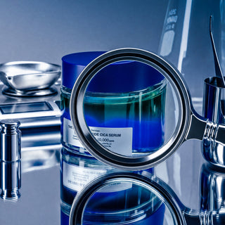 1% Blue Peptide Cica Serum jar seen through a magnifying glass in a lab setting