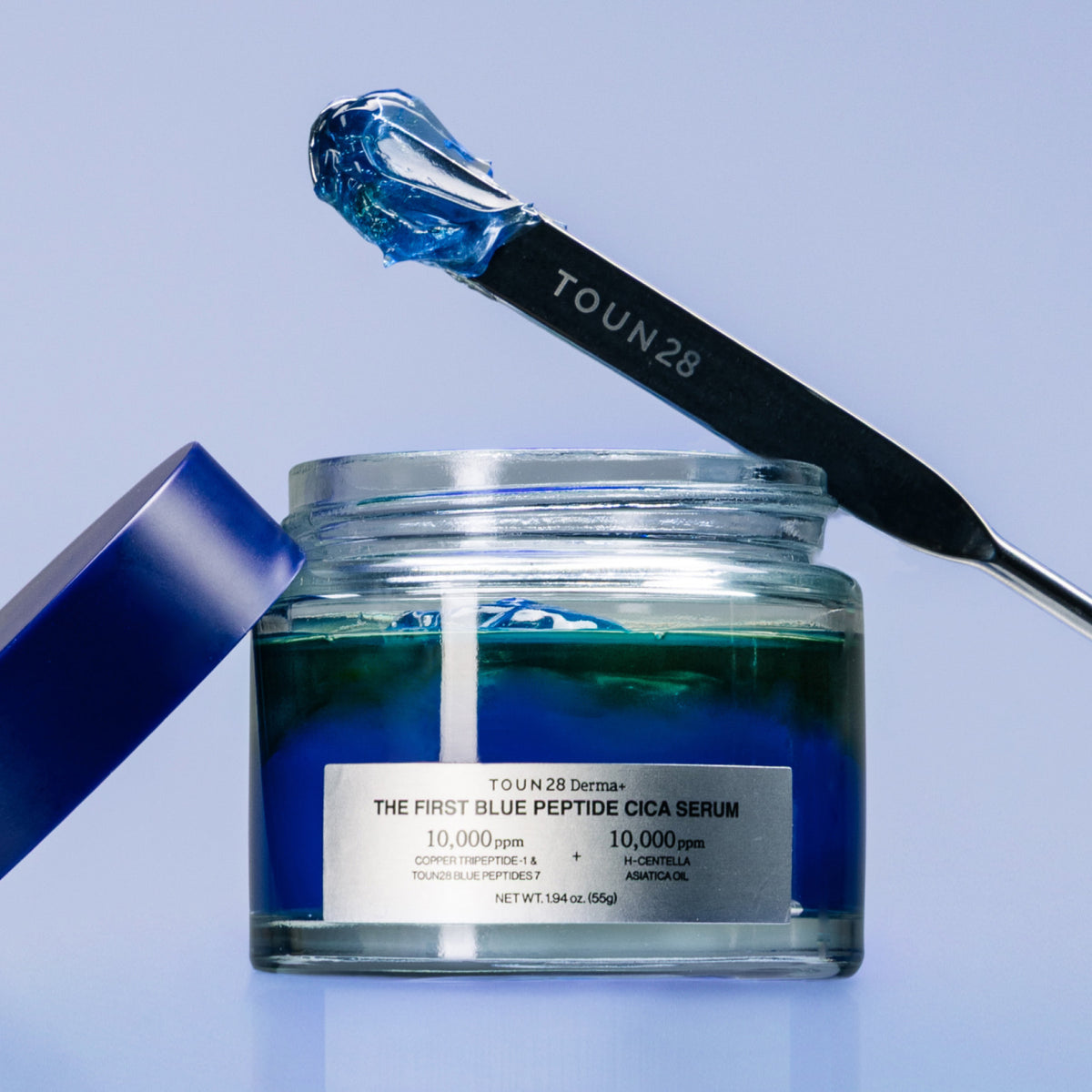 Open 1% Blue Peptide Cica Serum jar with TOUN28 spatula holding blue gel texture